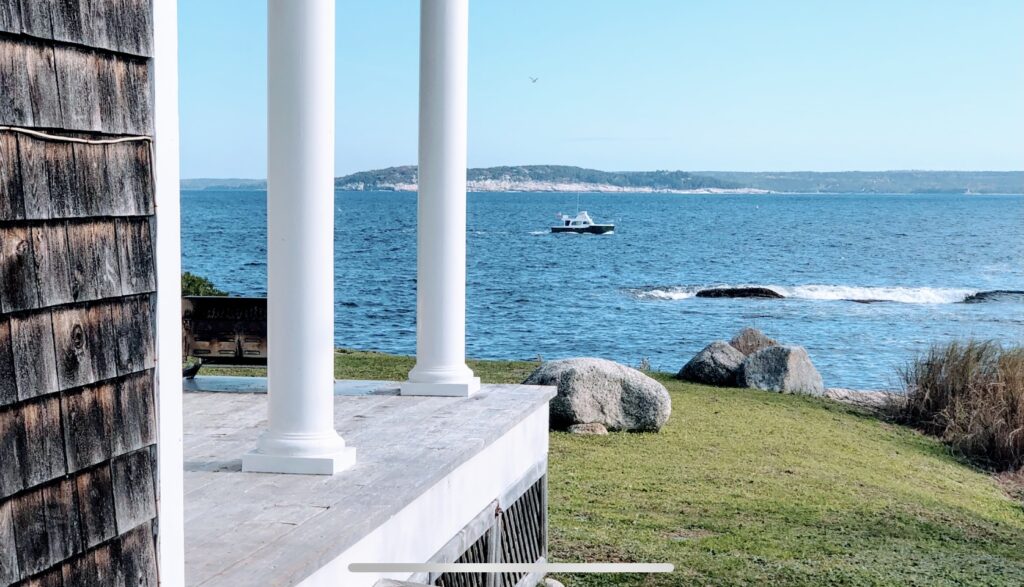 Looking across St. Margaret Bay at a boat and Shut-in Island